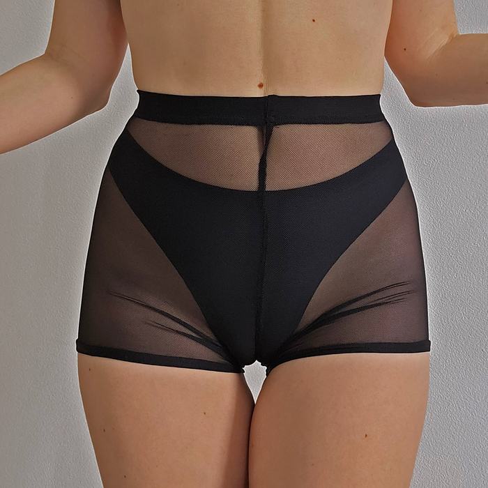 Black mesh shorts on a neutral background