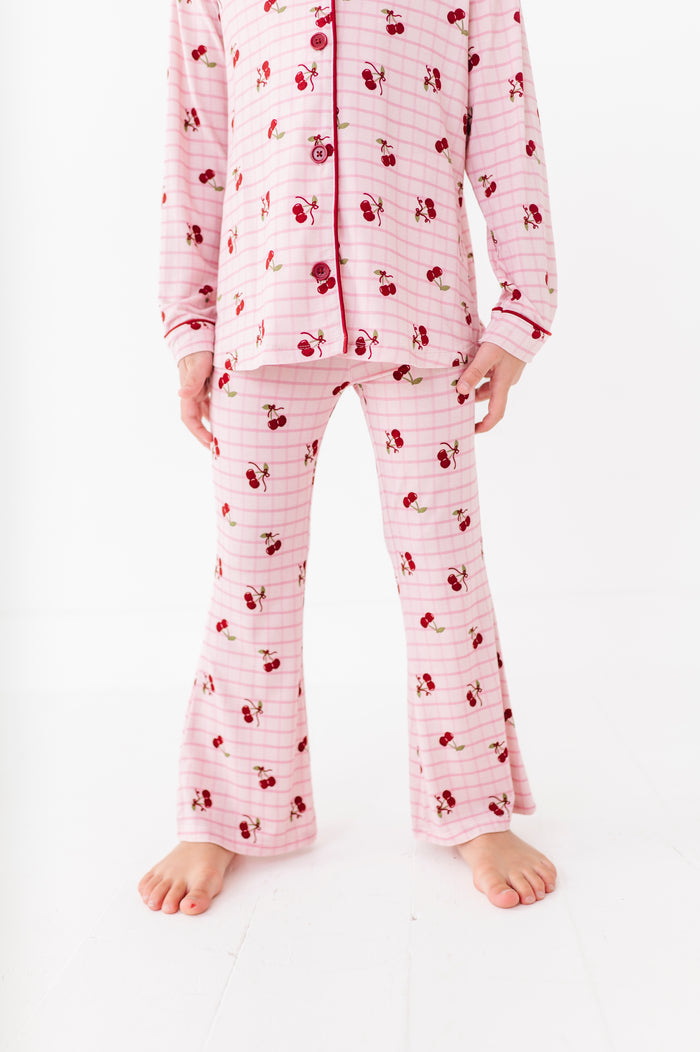 Pink pajama set with cherry pattern on a white background