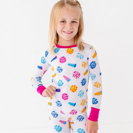 Child wearing a colorful pajama set with a white background