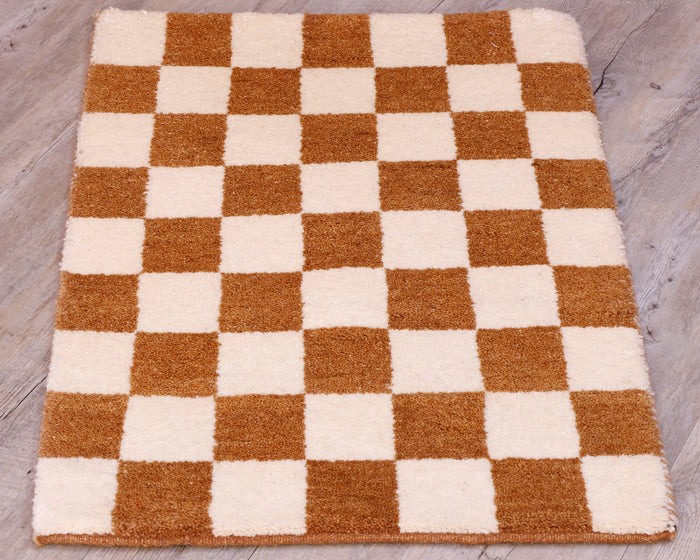 This small mat has a chequerboard design across it using cream and tan.