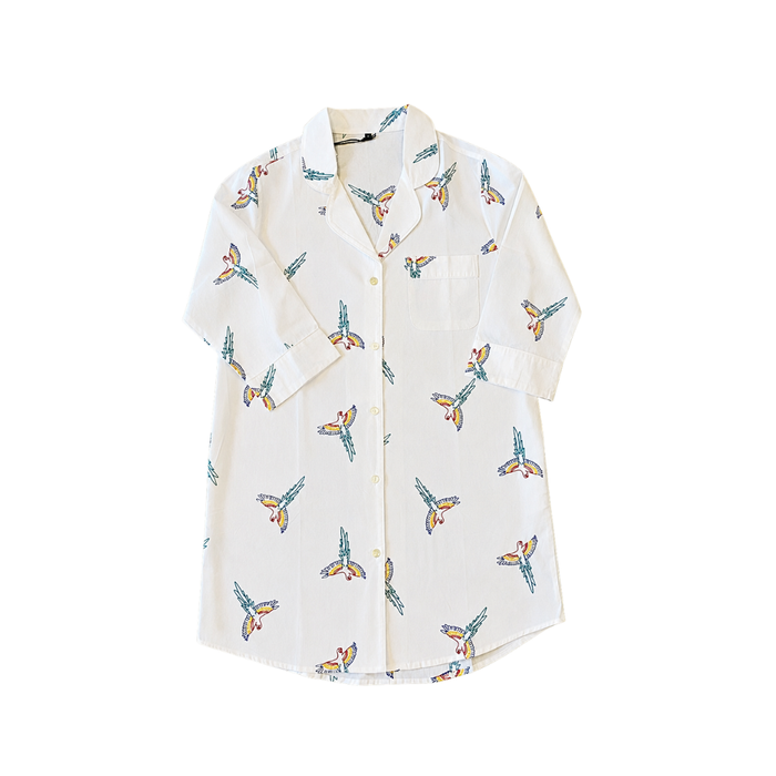 White shirt with colorful butterfly pattern on a white background. An X-Large white cotton long-sleeve button-down pajama top decorated with custom handloomed colorful parrot bird stitching.