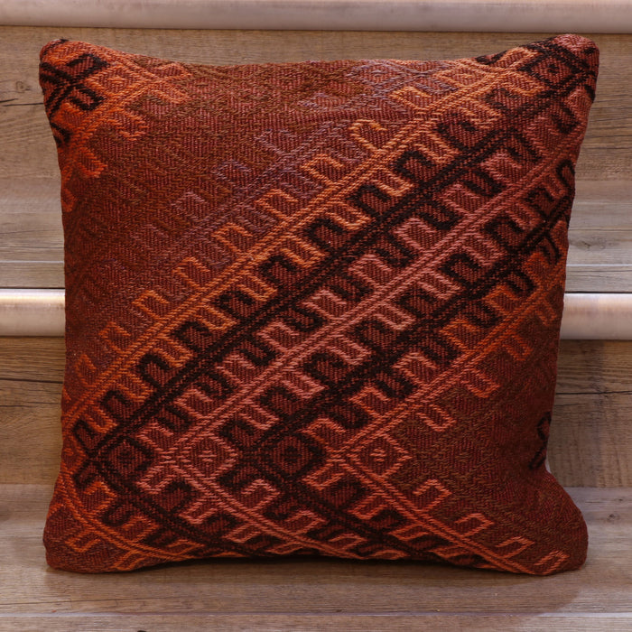 Geometric bands of decoration. Dusky pinky/red background.  Decoration in orange, black, pink and violet.