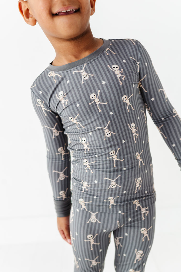 Kids Halloween PJs with cute skeletons for sibling matching and cozy memories